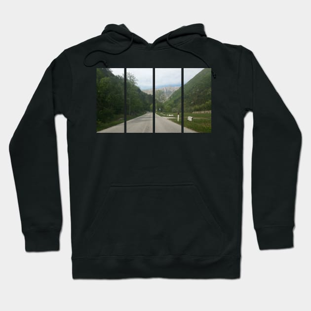 A shot on the move from behind the windshield of an electric car with alps mountains in front of it in a fresh sunny spring day. POV first person view shot on a asphalted mountain road Hoodie by fabbroni-art